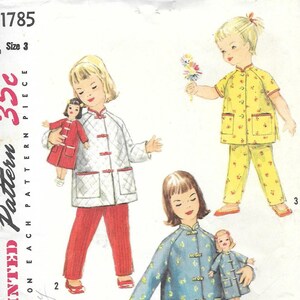 May include: Simplicity pattern 1785, size 3, featuring illustrations of children wearing mandarin-collar jackets and pants or coats with matching doll outfits. The designs include a white quilted jacket, a yellow floral set, and a blue floral coat.