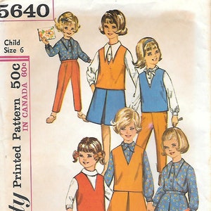 May include: Vintage Simplicity sewing pattern for children's clothing. The pattern features various outfits, including vests, skirts, pants, and dresses. The outfits are in shades of orange, blue, and white, with floral and solid patterns. The pattern is for a child size 6.