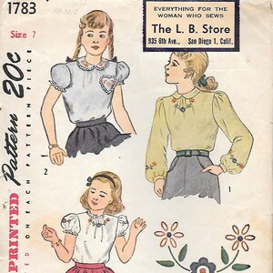 May include: Vintage Simplicity pattern 1783 for women's blouses. The pattern features illustrations of different blouse styles with floral embroidery and puff sleeves. The L. B. Store, San Diego, California, is printed on the pattern.