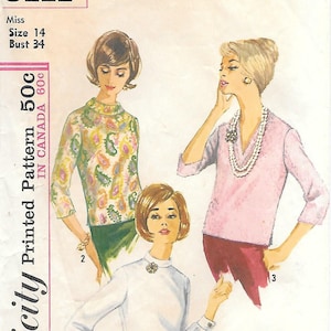 May include: Vintage Simplicity sewing pattern 5111 featuring three blouse designs. The pattern includes a white blouse, a pink V-neck blouse, and a paisley print blouse. The pattern is for Misses size 14 with a 34-inch bust.