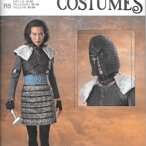 May include: Simplicity Costumes sewing pattern for fantasy and cosplay. The pattern includes a costume with a silver and black skirt, a blue belt, and a chainmail-style top. The image also shows a chainmail hood. The pattern size is U.S. 14-22.