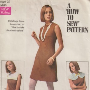 May include: Vintage Simplicity sewing pattern 8060, featuring a brown sleeveless dress and instructions for detachable collars. The pattern includes a tissue lesson chart. The image shows a woman wearing the dress and examples of the collars.