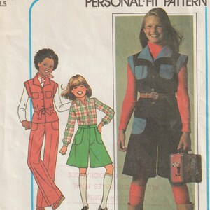 May include: Simplicity pattern 7906 for girls' clothing. The illustration shows three girls modeling different outfits, including a jumpsuit, shorts, and a shirt with shorts. The pattern includes sizes A (7 & 8).