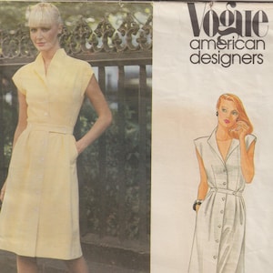 May include: A vintage Vogue American Designers sewing pattern featuring a yellow button-down dress with a belt. The pattern includes a photograph of the dress and an illustration. The text "adele simpson" is visible.