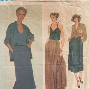 May include: Vogue American Designer sewing pattern featuring three women's outfits. The outfits include a teal dress with a matching jacket, a halter top with a long skirt, and a blazer with a skirt. The pattern is labeled "KASPER" and "1993".