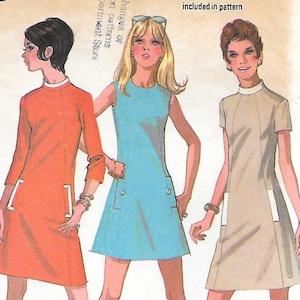 May include: Vintage McCall's sewing pattern 2355 for Misses' dresses in three versions. The pattern features illustrations of three dresses in orange, blue, and beige, with white accents. The pattern includes a two-color guide.