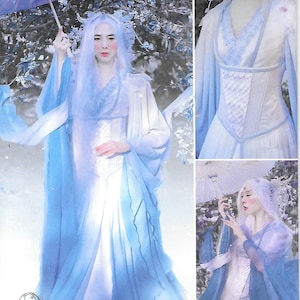 Puede incluir: El patrón Simplicity S8971 presenta un vestido de fantasía con tela fluida azul y blanca. El diseño incluye un corpiño con un panel decorativo y mangas largas y drapeadas. El patrón es para tallas Euro 32-40.