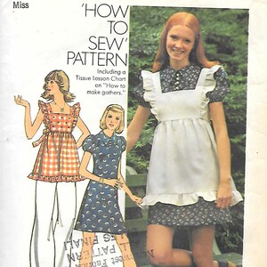 May include: Simplicity sewing pattern 6162 for a size 16 miss with a 38-inch bust. The envelope features illustrations of a plaid top with white pants and a blue floral dress with a white apron, plus a photograph of the dress and apron.