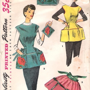 May include: A vintage Simplicity sewing pattern envelope numbered 4492, size Medium. The illustration displays three apron designs: a teal apron with red floral motifs, a yellow apron with pockets, and a pink gathered apron with green ties.