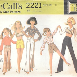 May include: Vintage McCall's 2221 sewing pattern for girls' separates. The illustration shows five girls in various outfits, including crop tops, shorts, and flared pants. The pattern includes sizes for girls' size 8.
