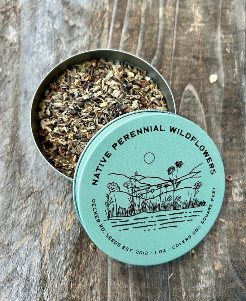 May include: A teal metal tin with a black and white illustration of a landscape with wildflowers and the text "NATIVE PERENNIAL WILDFLOWERS DECKER RD. SEEDS EST. 2012 - 1 OZ - COVERS 250 SQUARE FEET."