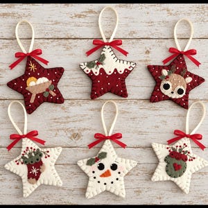 May include: Six star-shaped felt ornaments featuring festive designs including a manger, a pudding, a reindeer, a stocking, a snowman, and a mitten. Each ornament is stitched with white thread, topped with a red ribbon bow, and a cream hanging loop.