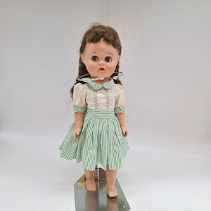Vintage doll 1950s hard plastic green sleep eyes braided brown wig unmarked 16&quot; multiple outfits