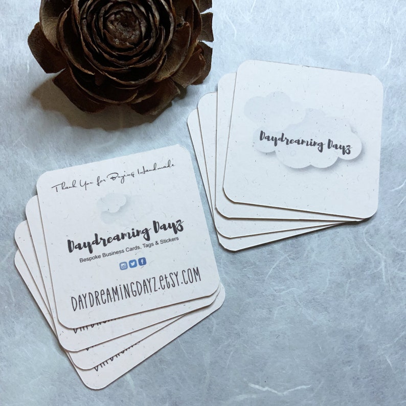 May include: A stack of white business cards with the text "Daydreaming Days" and the website "DAYDREAMINGDAYZ.etsy.com". The cards are made of recycled paper and have a speckled texture. The text "Thank you for buying handmade" is on the back of the cards.