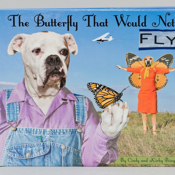 The Butterfly That Would Not Fly, third hardback book with dogs wearing clothes helping a monarch butterfly by Pringle of Dogtown Artworks