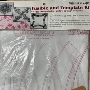 May include: A Fusible and Template Kit for Egg Money Quilts, featuring a variety of quilting patterns. The kit includes fusible interfacing and acrylic templates for various designs, including Grandmother's Flower Garden and Double Wedding Ring. The packaging includes the text "Quilt in a Day".