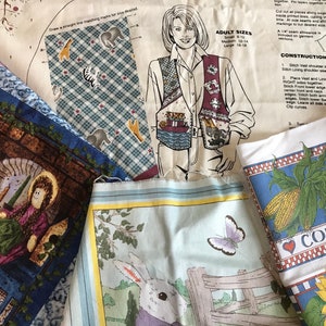 May include: A collection of fabric scraps featuring various designs, including a house with a girl in front, a blue and white checkered pattern with animal silhouettes, a blue and white corn design with the word "CORN" in red, and a light blue fabric with a rabbit and a butterfly.
