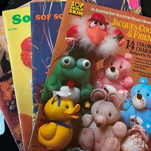May include: A book titled "Jacques Coo Crow & Friends" with a colorful illustration of 14 soft sculpture characters. The book is a project book for making soft sculptures and includes step-by-step instructions, full-size patterns, and photos.