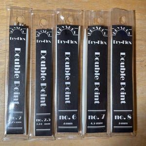 May include: Five packages of Bry-Flex Double Point needles. Each package has a black label with white text. The sizes are no. 2, no. 2.5, no. 6, no. 7, and no. 8. The needles are in clear plastic packaging.