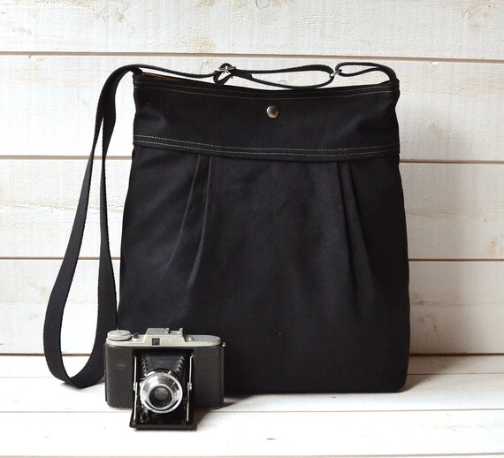 green and black diaper bag