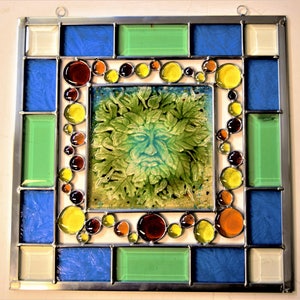 A unique stained glass panel with a fused glass Green Man in the middle.
