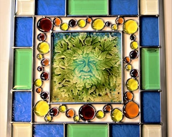 A unique stained glass panel with a fused glass Green Man in the middle.
