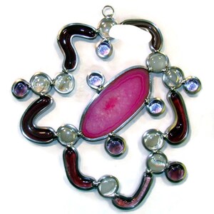 Suncatcher inspired by the Hubble Telescope.  Nebula designs in stained glass and a agate slice.  Ready to hang with ring on top.