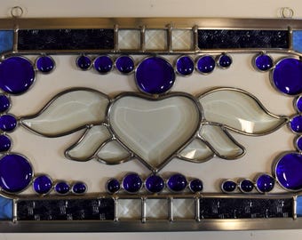 Stained glass panel with beveled flying heart.  Bright colors to brighten anyones day.