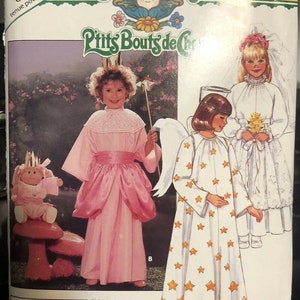 May include: A vintage Cabbage Patch Kids pattern featuring three children's costume designs. One child is in a pink princess dress, another in a star-patterned angel costume, and a third in a white wedding dress. The pattern includes the text "P'tits Bouts de Chou."