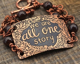 We Are All One Story bracelet, dark red garnet beads and etched copper, phrase jewelry, 7 1/2 inches long