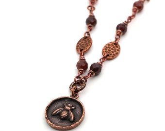 Bee necklace with reddish brown hessonite garnet beads and copper tone chain, 19 1/2 inches long