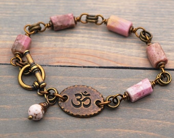 Pink stone om bracelet, rhodonite semiprecious stone beads, brass tones, fits 6 1/4 inch wrist, 7 1/2 inches long