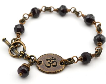 Garnet om bracelet, dark red semiprecious stone beads, brass tones, fits 6 1/4 inch wrist, 7 3/4 inches long