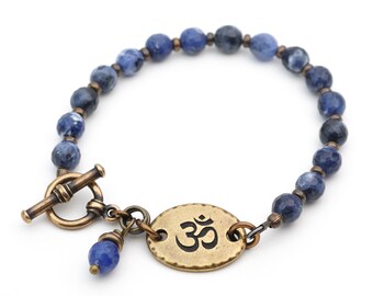 Sodalite Om bracelet, blue and white beads, brass tones and semiprecious stone, 7 1/4 inches long, fits 6 1/4 inch wrist