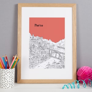 May include: Framed art print featuring a detailed black and white illustration of Porto, Portugal, with a salmon-colored sky and the city's name in black. The print is in a light wood frame.