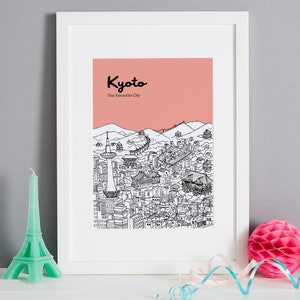 May include: A framed print with a pink background and a black and white illustration of the Kyoto skyline. The text "Kyoto" and "Our Favorite City" is printed in black at the top of the print.