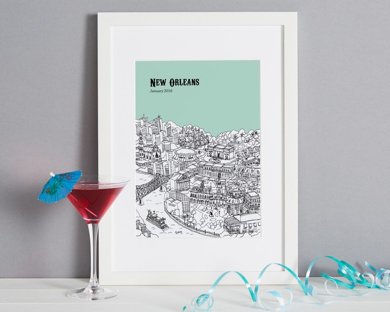 May include: A framed print of a black and white illustration of the New Orleans skyline with the text "NEW ORLEANS" and "January 2016" on a light green background.