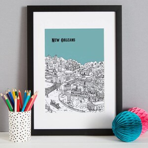 May include: Black and white line drawing of the New Orleans skyline with the text "NEW ORLEANS" at the top. The drawing is on a light blue background and is framed in a black frame.