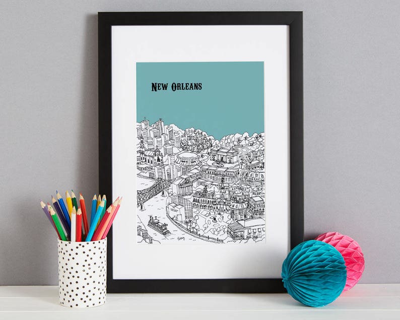 May include: Black and white line drawing of the New Orleans skyline with the text "NEW ORLEANS" at the top. The drawing is on a light blue background and is framed in a black frame.