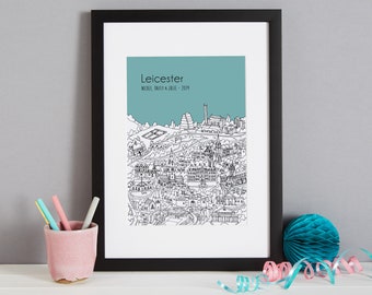May include: A black framed print of a line drawing of the city of Leicester, England. The print has a teal background and the text "Leicester, NICOLA, DARYL & JULIE - 2019" at the top.