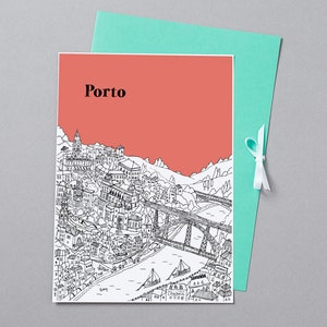 May include: A greeting card featuring a black and white illustration of Porto, Portugal, with the city's name in black text against a coral background. The card is paired with a teal envelope tied with a white ribbon.