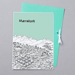 May include: A black and white line drawing of a city skyline with mountains in the background. The city is labeled "Marrakech" in black text.