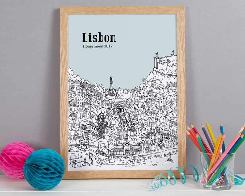 May include: A black and white line drawing of the city of Lisbon, Portugal. The drawing includes the city's iconic landmarks, such as the Jer&oacute;nimos Monastery and the Bel&eacute;m Tower. The text "Lisbon Honeymoon 2017" is printed at the top of the drawing.