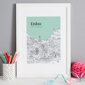 May include: A black and white line drawing of the city of Lisbon, Portugal, with the text "Lisbon" and "Where it all begins..." on a light green background. The drawing is framed in a white frame.