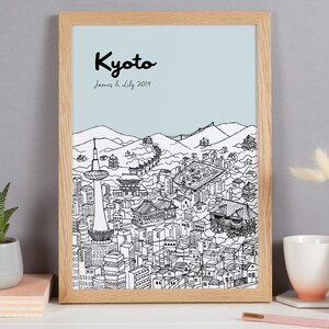 May include: A framed black and white line drawing of the Kyoto skyline with the text "Kyoto" and "James & Lily 2014" printed below the image.