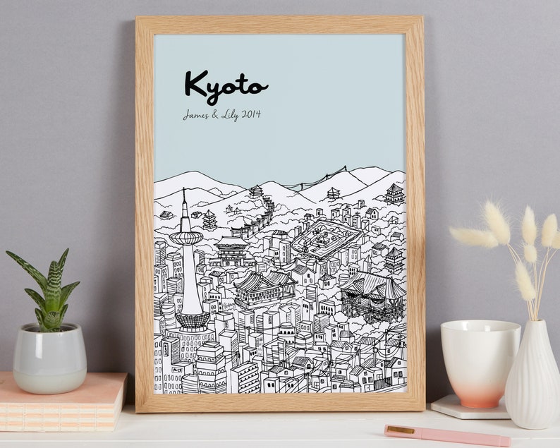 May include: A framed black and white line drawing of the Kyoto skyline with the text "Kyoto" and "James & Lily 2014" printed below the image.