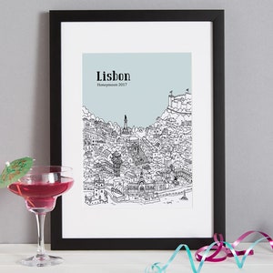 May include: A black framed print with a line drawing of Lisbon, Portugal. The print has a light blue background and the text "Lisbon Honeymoon 2017" is printed at the top.