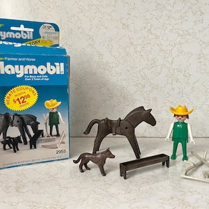 May include: Playmobil toy set featuring a farmer, a horse, a dog, a rake, and a trough. The set is packaged in a blue and white box with the Playmobil logo and the words "Farmer and Horse".
