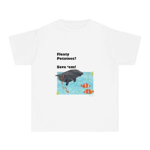 May include: White t-shirt with a cartoon manatee and clownfish design inside a blue rectangle. The text "Floaty Potatoes? Save 'em!" is printed above the illustration in black.
