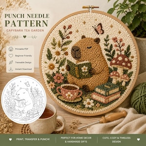 May include: A punch needle pattern featuring a capybara reading a book in a tea garden setting. The design includes flowers, mushrooms, and a teacup, all within a wooden embroidery hoop. The text reads "CAPYBARA TEA GARDEN".